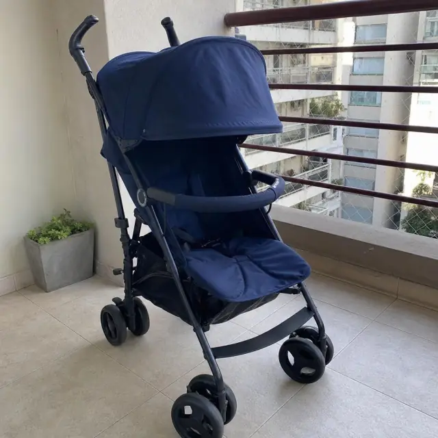 Navy blue stroller on a balcony